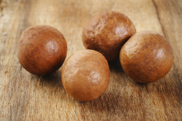macadamia on wood background