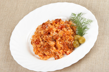 Risotto with meat, mushrooms and tomato sauce