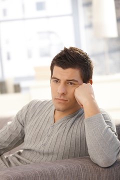 Young man thinking on sofa