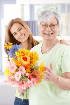 Happy senior mother with flowers at mother's day