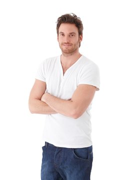 Young man in tshirt and jeans smiling