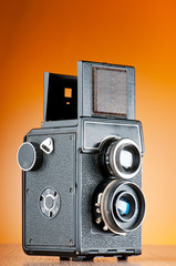 Vintage film camera against gradient background