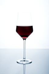 Red wine glass isolated on white background standing on a table