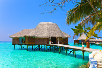 Island in ocean, overwater villa.Maldives. .