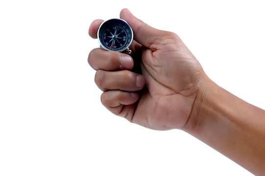 man's hand holding a compass