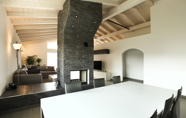 Modern architecture , interior, view from dining table. Large modern apartment in an unlit central fireplace