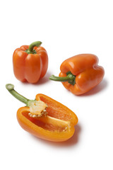 Whole and half orange bell peppers