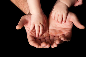 the hands of father and child
