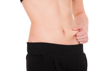 girl measures fat on her stomach