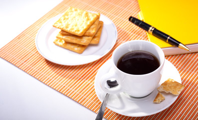 hot coffee cup with bread on the work space