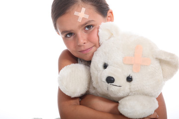 Girl and teddy with a plaster
