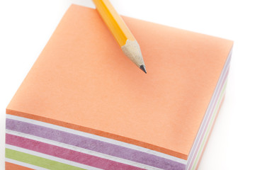 A colorful note pad with a pencil