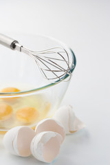 Fototapeta na wymiar Whisk with eggs in a bowl
