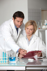 A man and a woman working in a lab.