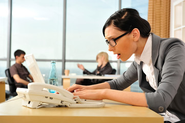 Closeup portrait of cute young business woman using laptop