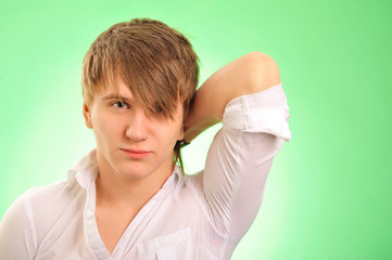 Portrait of a handsome young man over green background