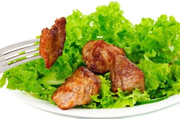 Meat on leaf lettuce on plate
