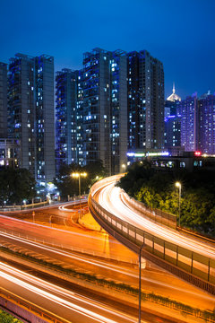 light trails on the viaduct in bustling city at night