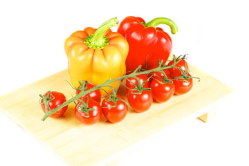 fresh and juicy vegetables on the wood plate isolated
