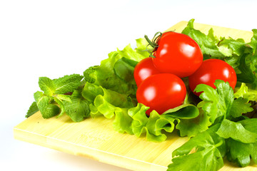 fresh and juicy vegetables on the wood plate isolated
