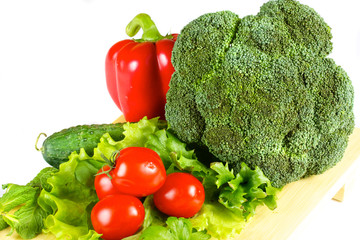 fresh and juicy vegetables on the wood plate isolated