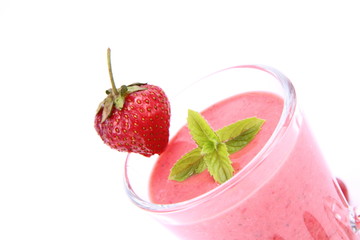Strawberry shake in a glass with a strawberry and mint