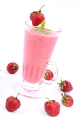 Strawberry shake in a glass with strawberries and mint