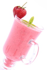 Strawberry shake in a glass with a strawberry and mint
