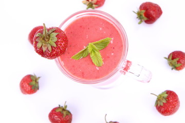 Strawberry shake in a glass with strawberries and mint