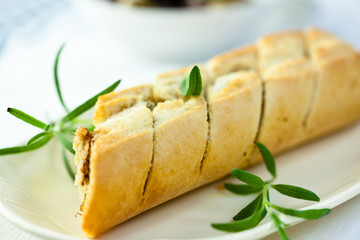 Baked baguette flavoured with herbs