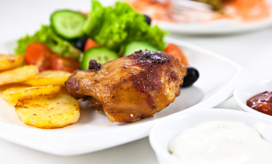 Roasted chicken with potatoes and salad