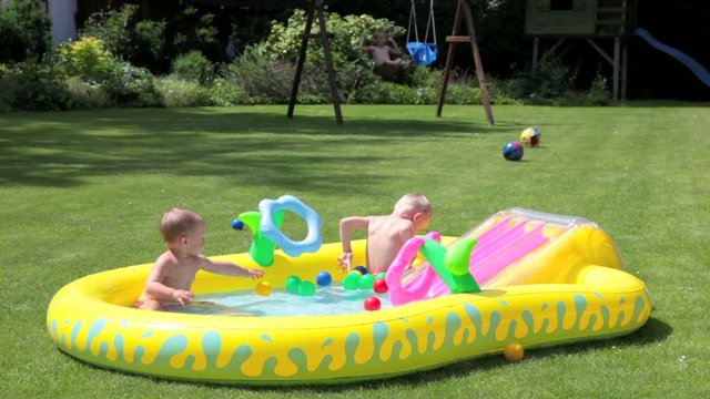 Children splashing water in swimming pool