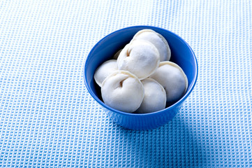 ravioli on blue background