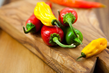 Colorful peppers on cutting board