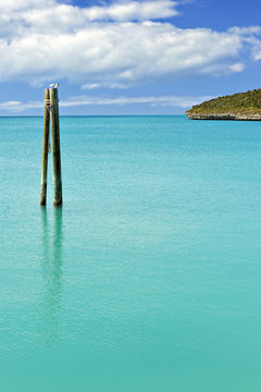 Mooring posts in turquoise blue sea in Governor's Harbour