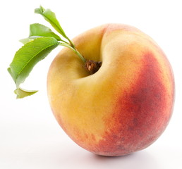 Ripe peach with leaves