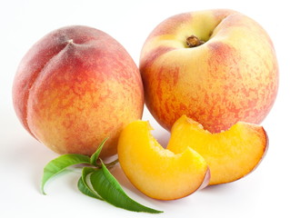 Ripe peach fruit with leaves and slises