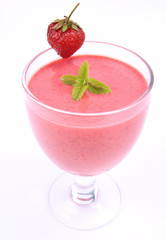 Strawberry shake in a glass with a strawberry and mint