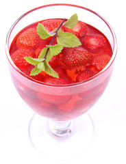 Jelly with strawberries decorated with a mint twig