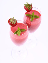 Strawberry shake in champagne glasses with strawberry and mint