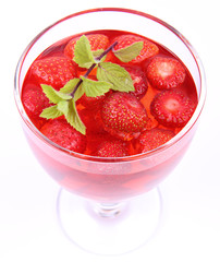 Jelly with strawberries decorated with a mint twig