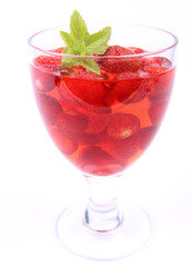 Jelly with strawberries decorated with a mint twig