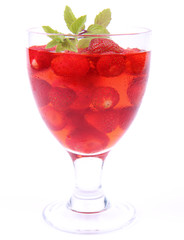 Jelly with strawberries decorated with a mint twig
