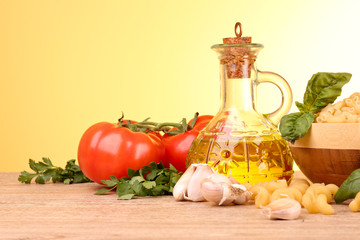 spaghetti with garlic, onion, spices  and basil on a yellow back