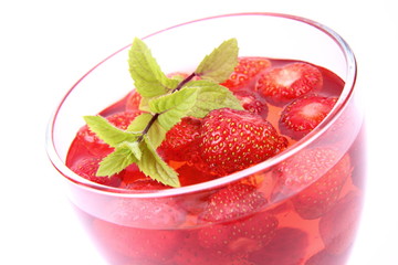 Jelly with strawberries decorated with a mint twig