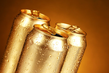 golden tin cans on yellow background