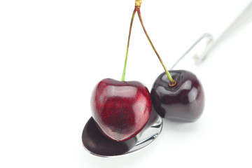 spoon and cherry isolated on white
