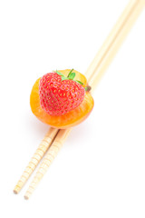 apricot,strawberry and chopsticks isolated on white