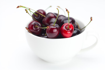 cherries in a bowl isolated on white