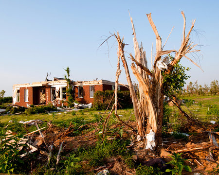Tornado-damaged land and home in northern Alabama